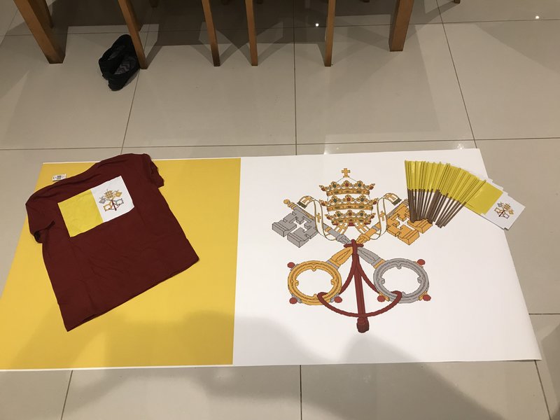 red-and-yellow-symbols-on-white-banner-with-t-shirt-and-flags